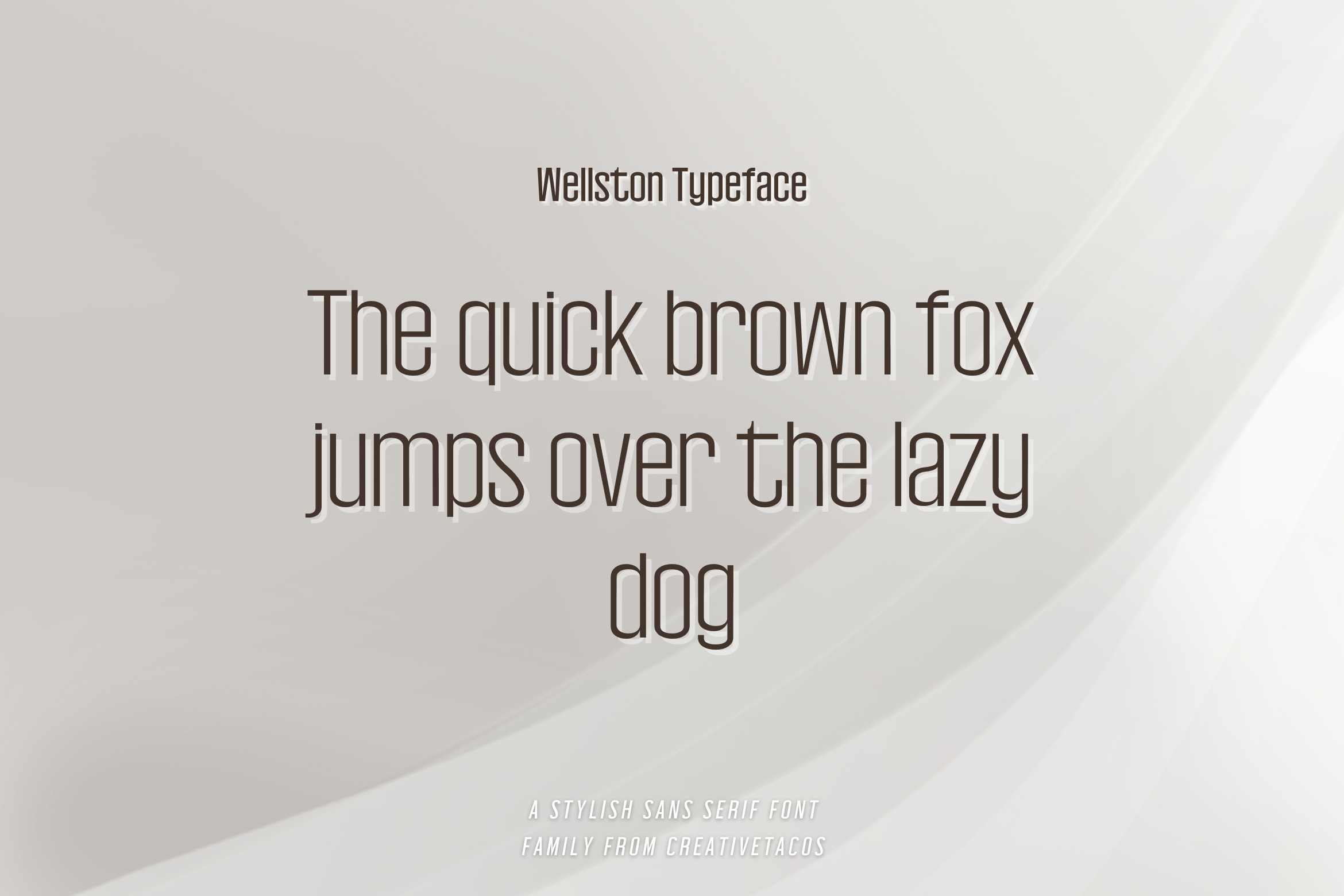 A soft gray and white gradient background showcasing the Wellston typeface with the classic pangram "The quick brown fox jumps over the lazy dog